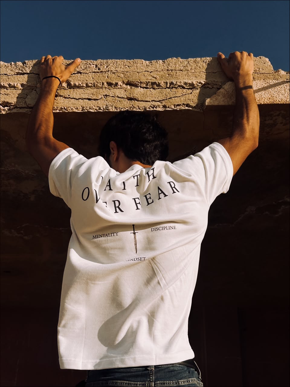 Close view of the white tee back print in full sunlight