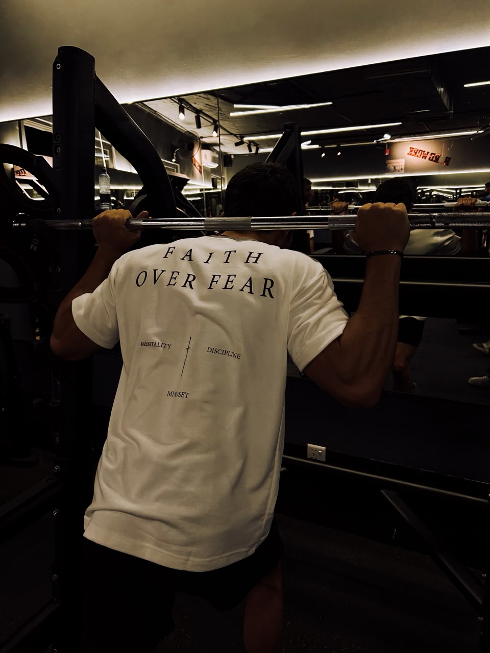 Under the bar in the white tee