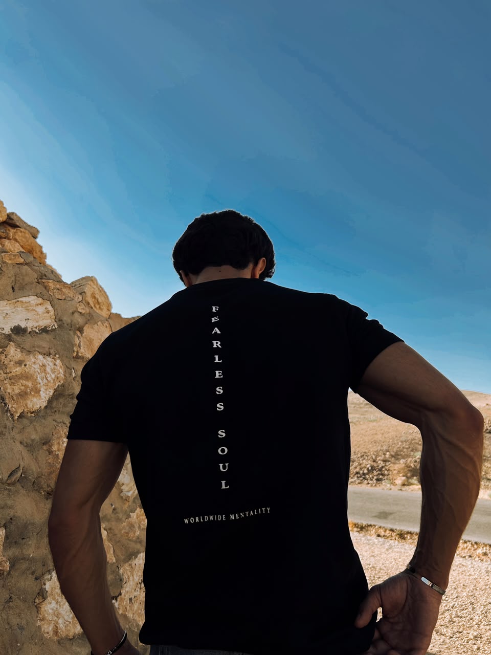The black Fearless Soul tee against a blue sky