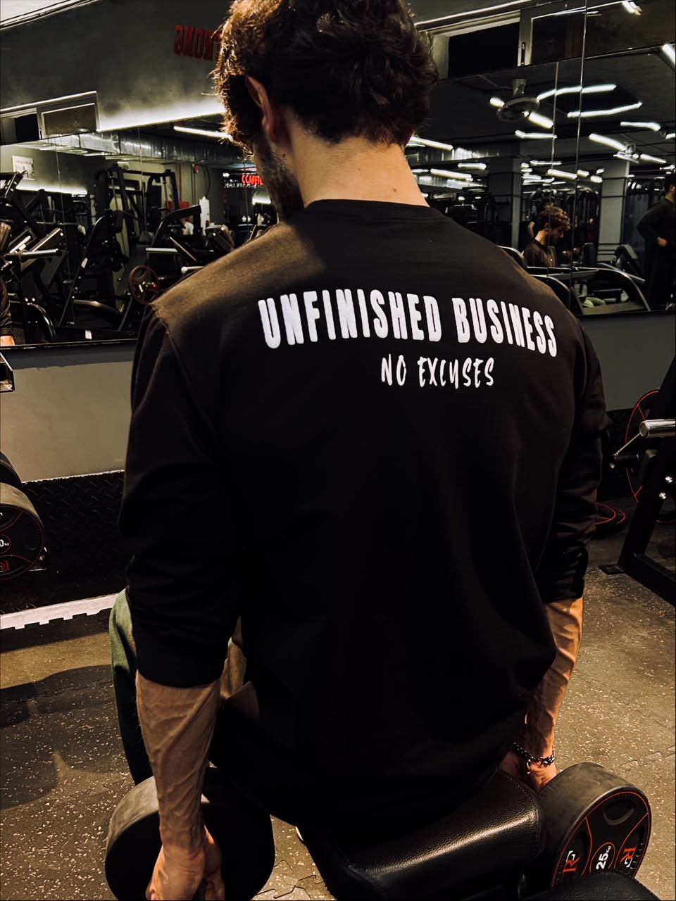 Back of the Unfinished Business long sleeve in the gym